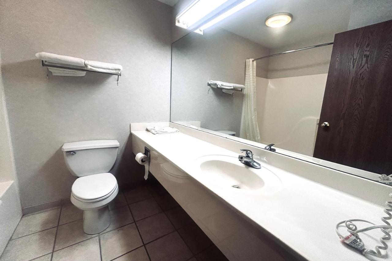 White toilet sits at pet-friendly Osage Village Inn Near Lake Ozarks US 54 in Osage Beach, MO.