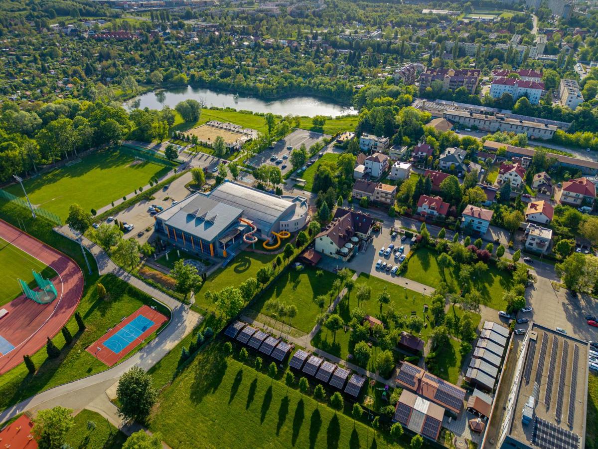 Gray building with yellow water slides sits at dog-friendly Hotel Kantoria in Tarnow.
