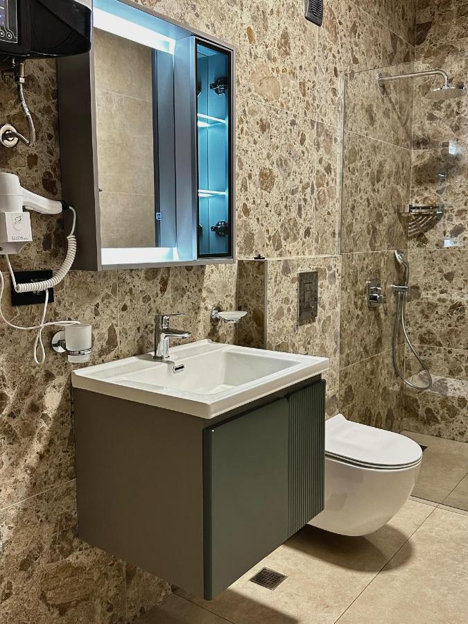 White ceramic sink with chrome faucet is mounted on vanity at pet-friendly Casa Mila Apartments & Bungalows in Ulcinj.