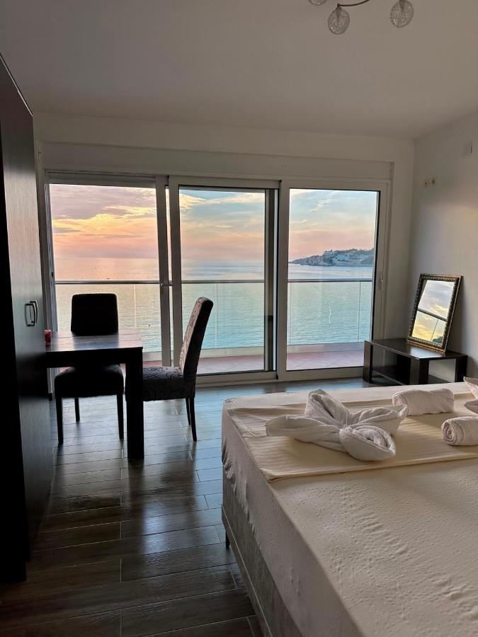 White bed with towel swans faces glass balcony doors at pet-friendly Casa Mila Apartments & Bungalows in Ulcinj.