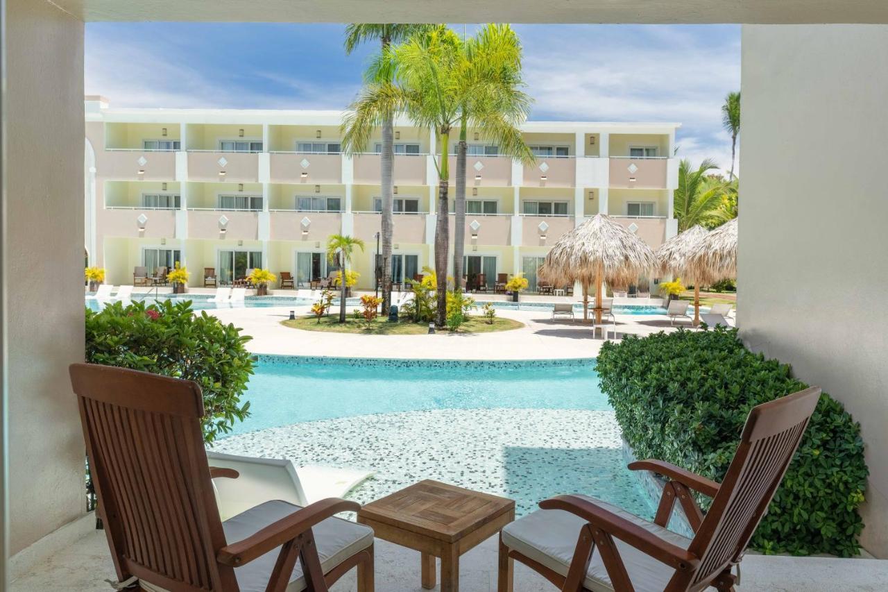 Two white chairs face pool at dog-friendly TRS Turquesa Hotel - Adults Only - All Inclusive in Punta Cana.