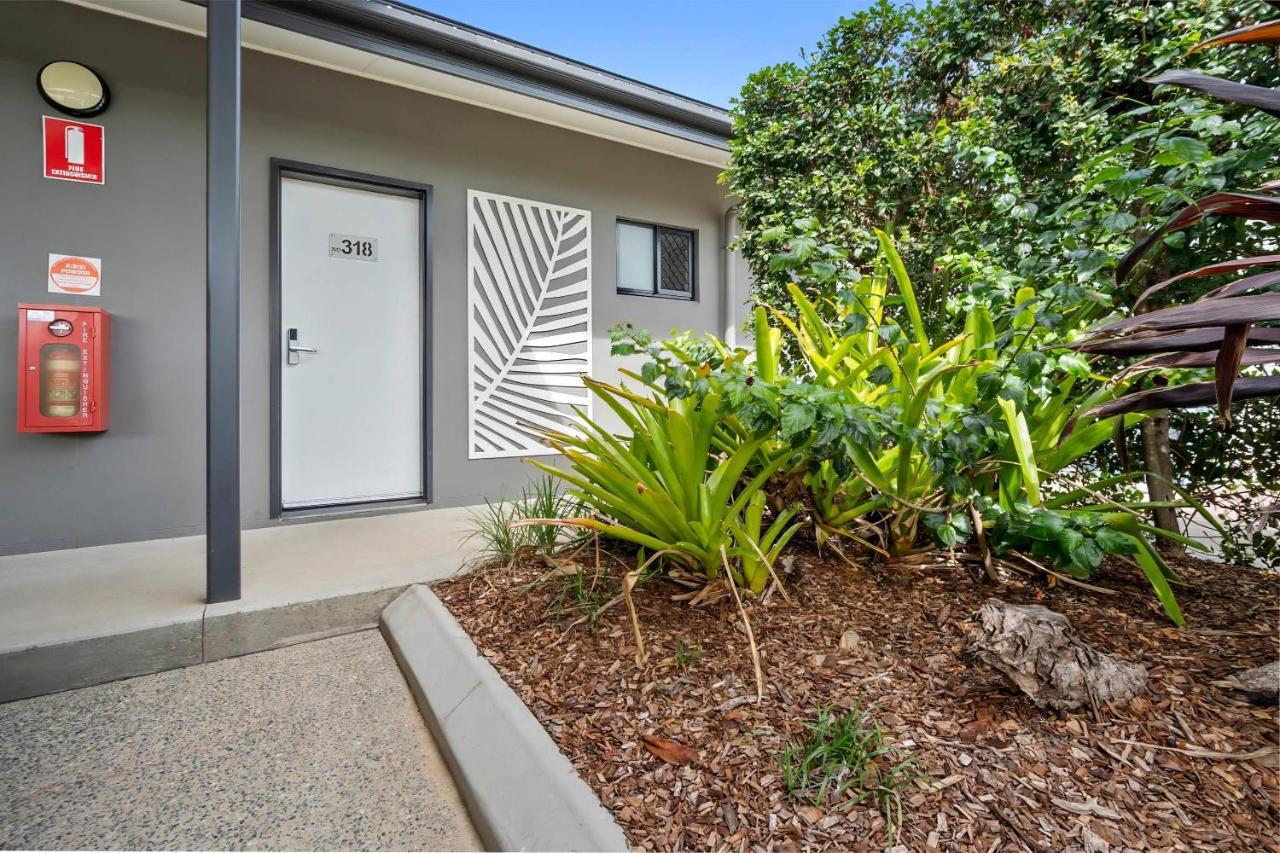 White door numbered 318 stands beside green landscaped planter at pet-friendly Korte's Resort in Rockhampton.