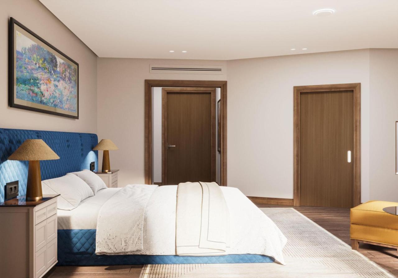 Blue quilted bed sits at dog-friendly Excelsior Hotel & Spa Baku Curio Collection by Hilton in Baku.