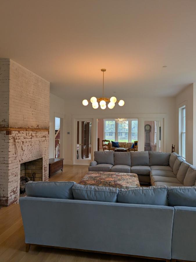 Light-gray sectional sofa sits at dog-friendly Parkway House Goshen Bed and Breakfast Suite 1 in Goshen, NY.