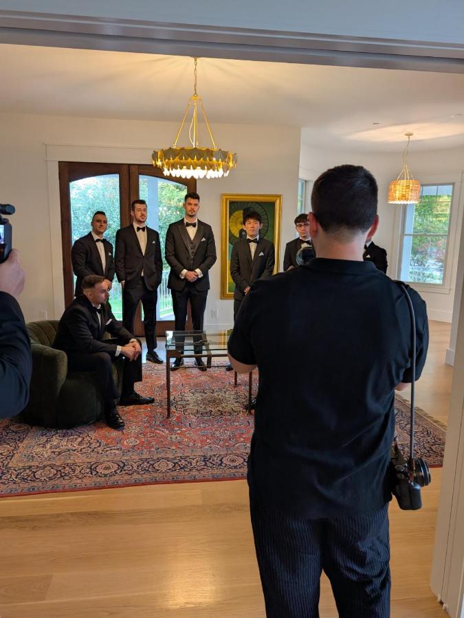 Photographer in black shirt standing at dog-friendly Parkway House Goshen Bed and Breakfast Suite 1 in Goshen, NY.