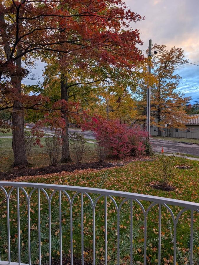 White metal railing overlooks street at dog-friendly Parkway House Goshen Bed and Breakfast Suite 1 in Goshen, NY.