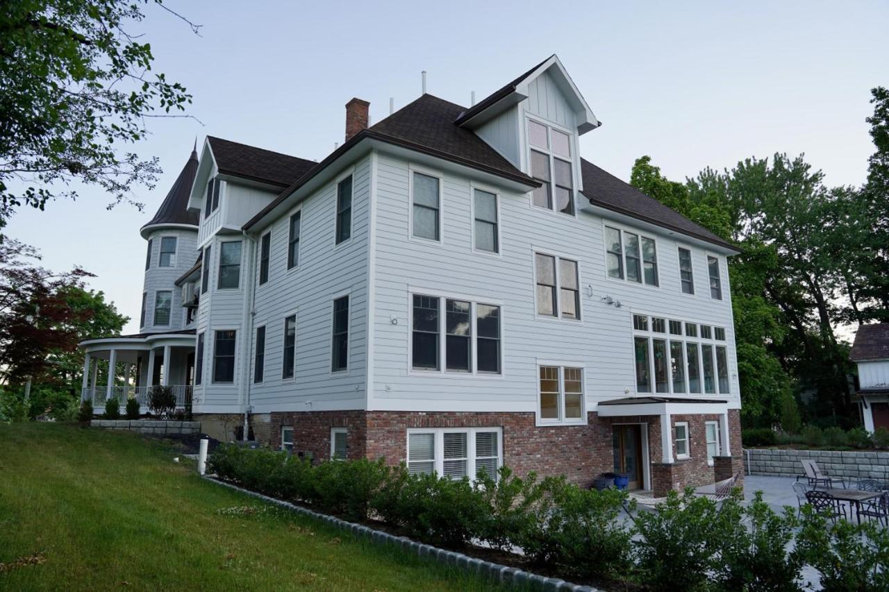 White Victorian house with turret sits at dog-friendly Parkway House Goshen Bed and Breakfast Suite 1 in Goshen, NY.