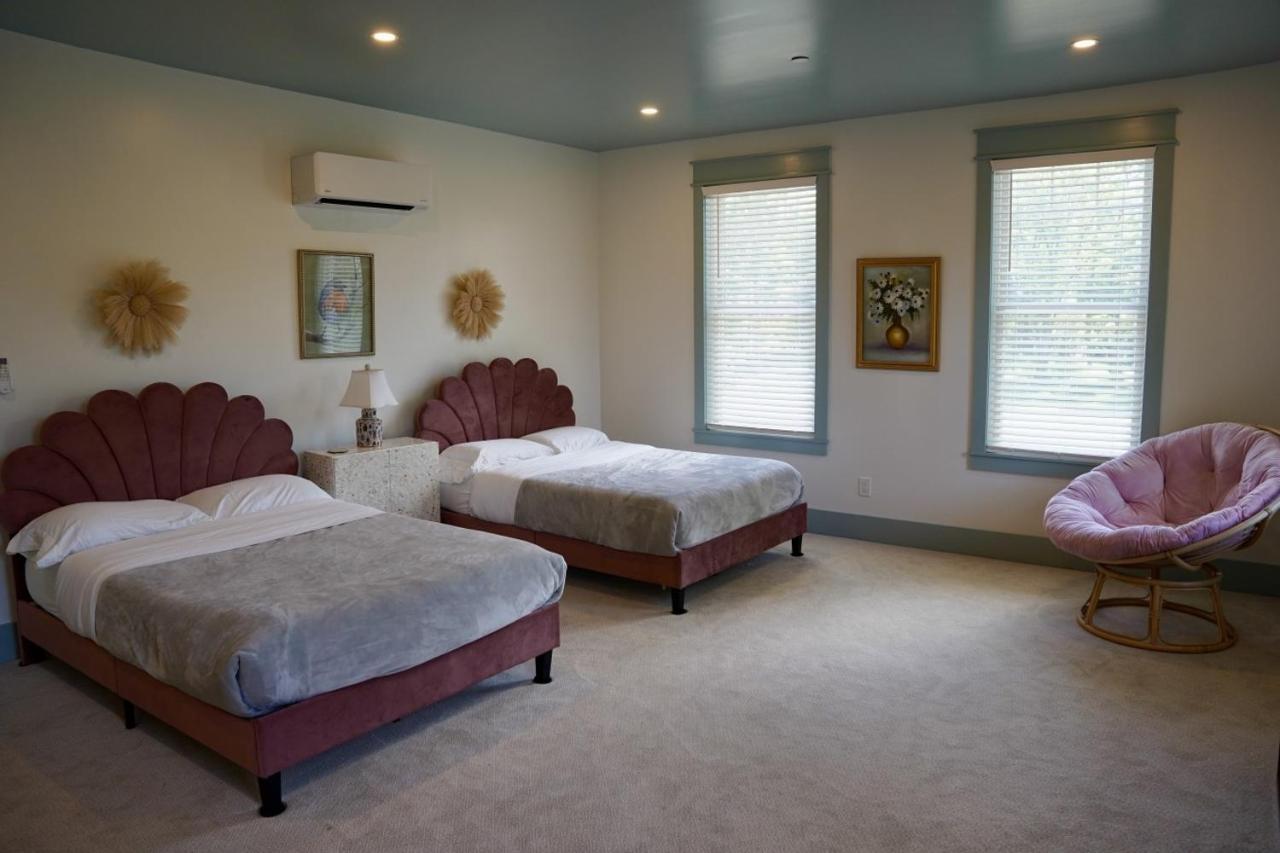 Mauve scalloped-headboard beds sit at pet-friendly Parkway House Goshen Bed and Breakfast Suite 1 in Goshen, NY.