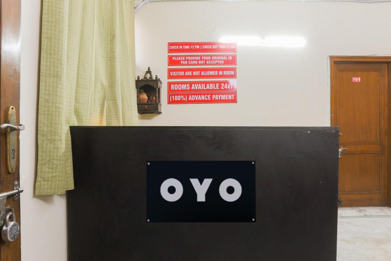 Dark brown reception desk with black OYO sign stands at dog-friendly Hotel O Jps DC Residency in New Delhi.