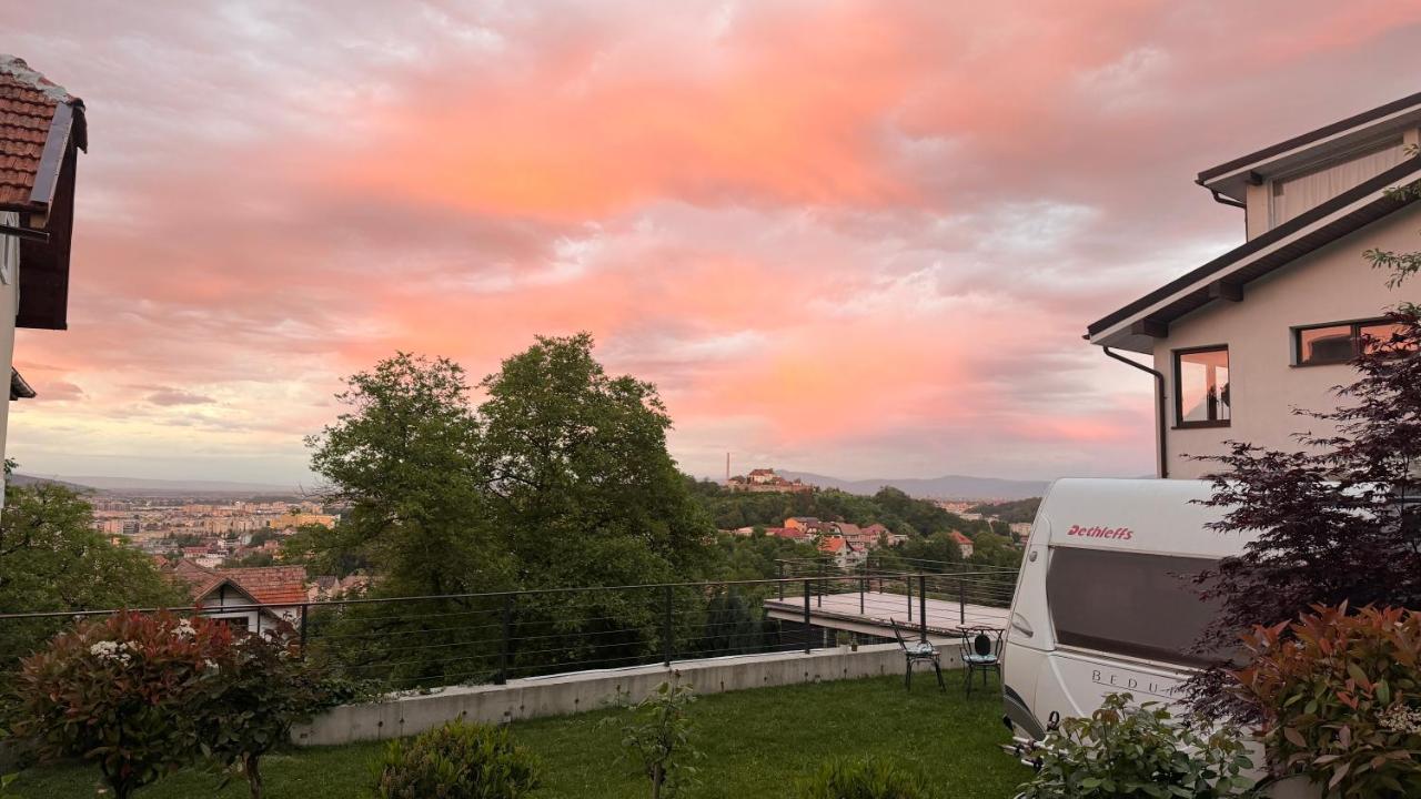 White campervan with red lettering is parked at pet-friendly Campervan Romantic Getaway in Old Town Brasov in Brasov.