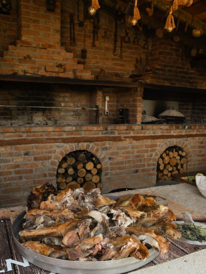 Large metal tray of browned roasted meat sits at dog-friendly Vatra Traditional Guesthouse in Tepelenë.