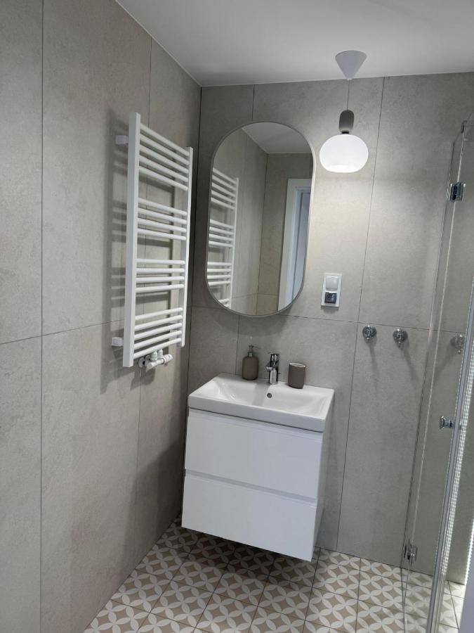 White wall-mounted sink cabinet with chrome faucet stands at pet-friendly Port Rewa in Rewa.