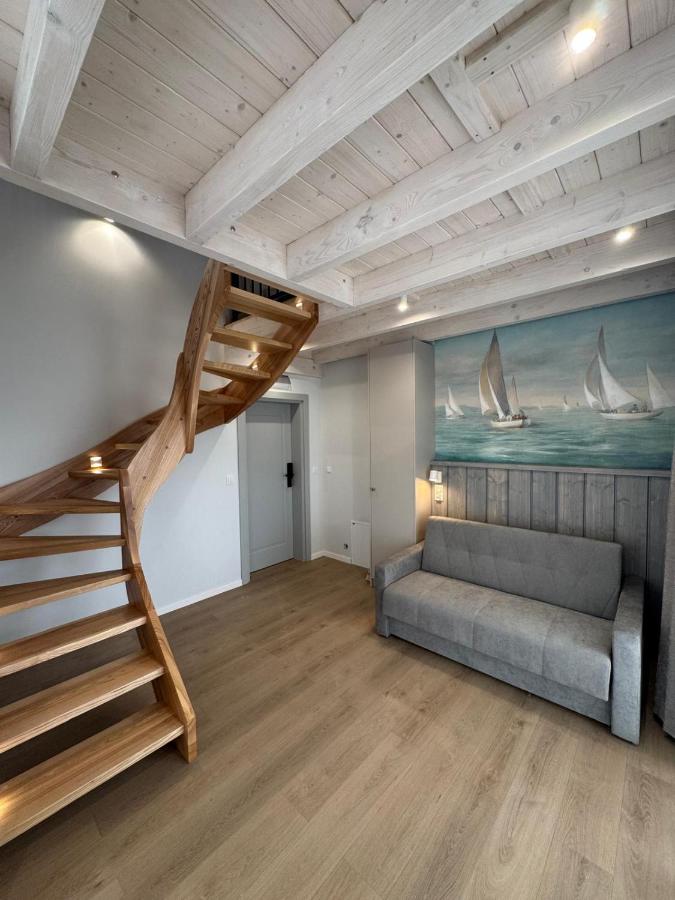 Curved light wood staircase ascends at pet-friendly Port Rewa in Rewa.
