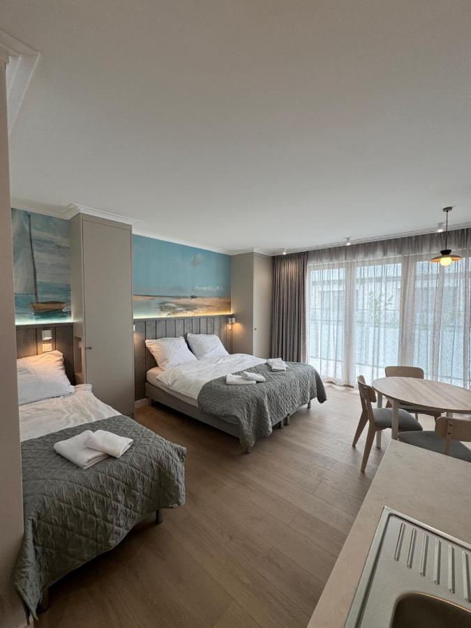 Two gray quilted beds with white towels sit at dog-friendly Port Rewa in Rewa.