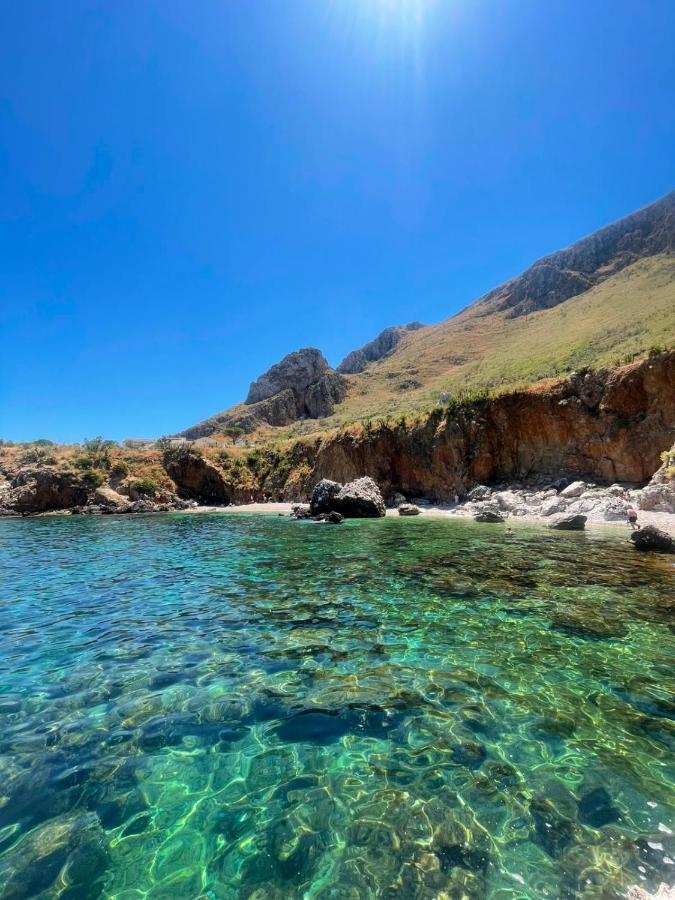 Clear turquoise water laps at dog-friendly Terra d'Amare in Castelluzzo.