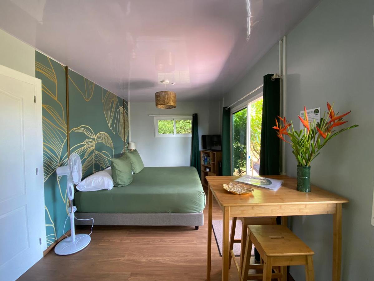 Green bed with matching pillows sits at dog-friendly Fare Maraea in Vaiare.