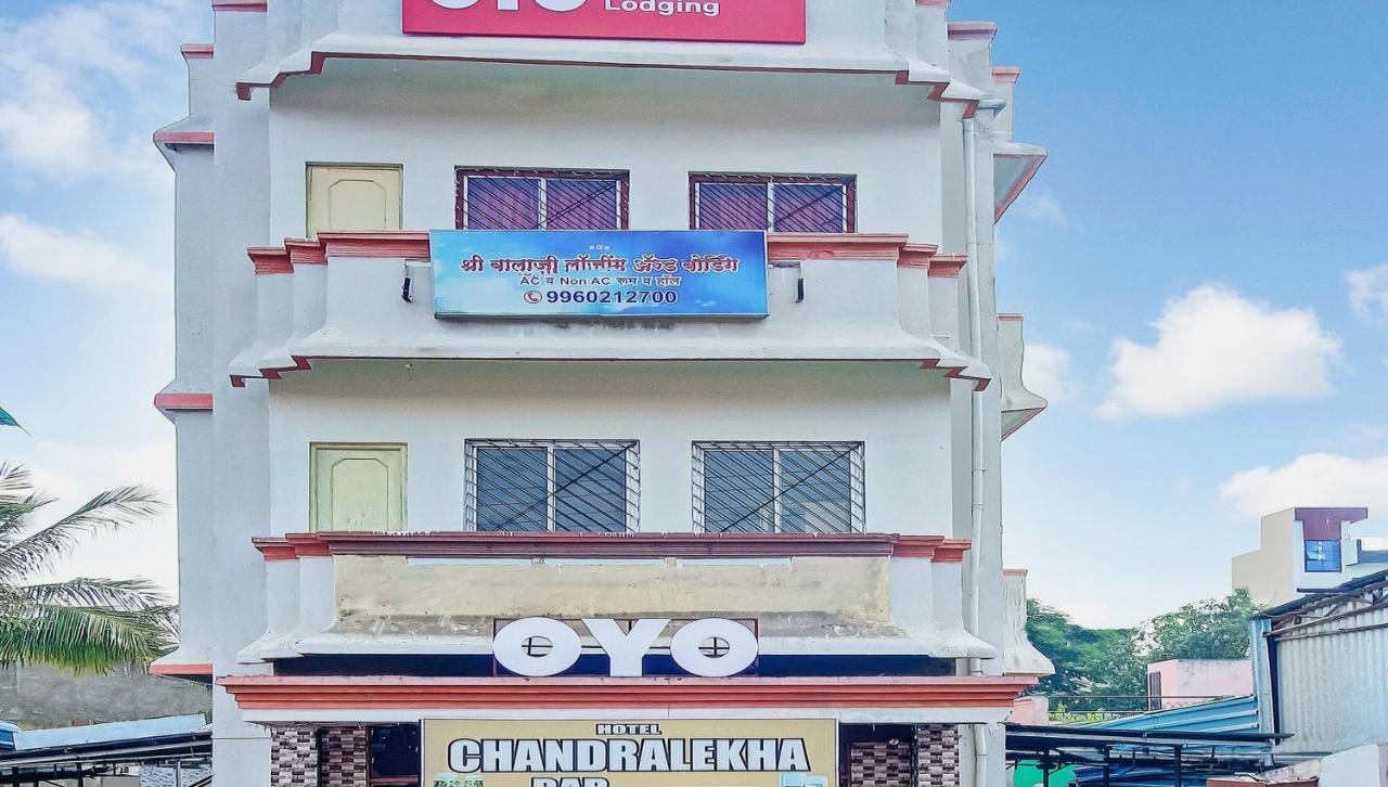 White three-story building with red trim stands at dog-friendly Hotel O Shree Balaji Lodging in Cidco.