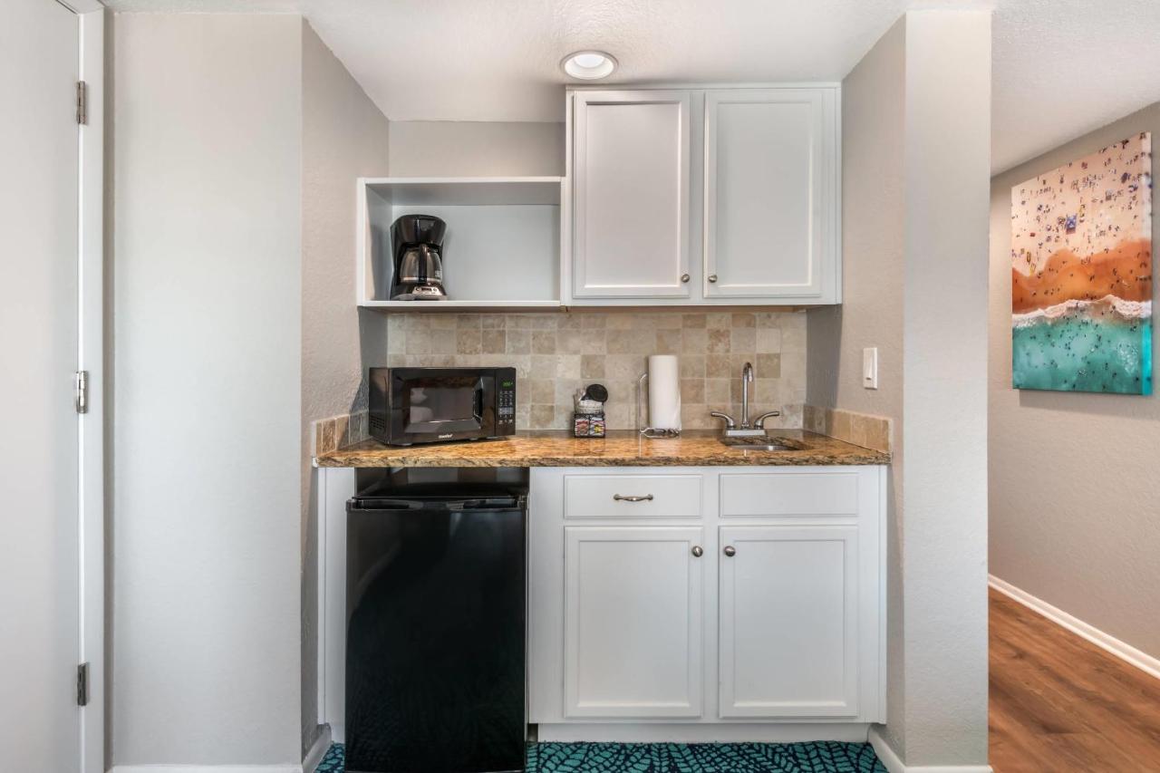 White kitchenette sits at pet-friendly Coconut Palms Beach Resort II an Ascend Collection Hotel in New Smyrna Beach, FL.