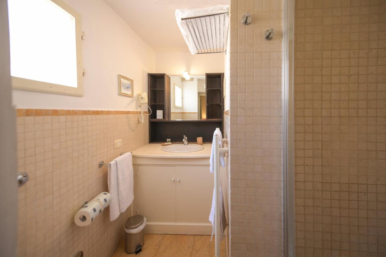 A cream sink cabinet with round white basin sits at dog-friendly Casa Rovai Guest House in Florence.
