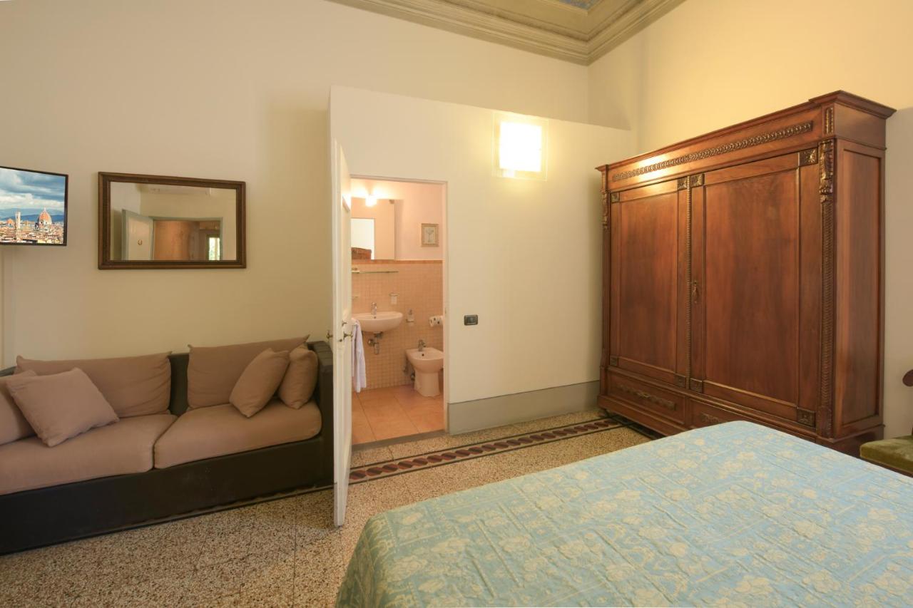 Beige sofa with tan cushions sits at dog-friendly Casa Rovai Guest House in Florence.
