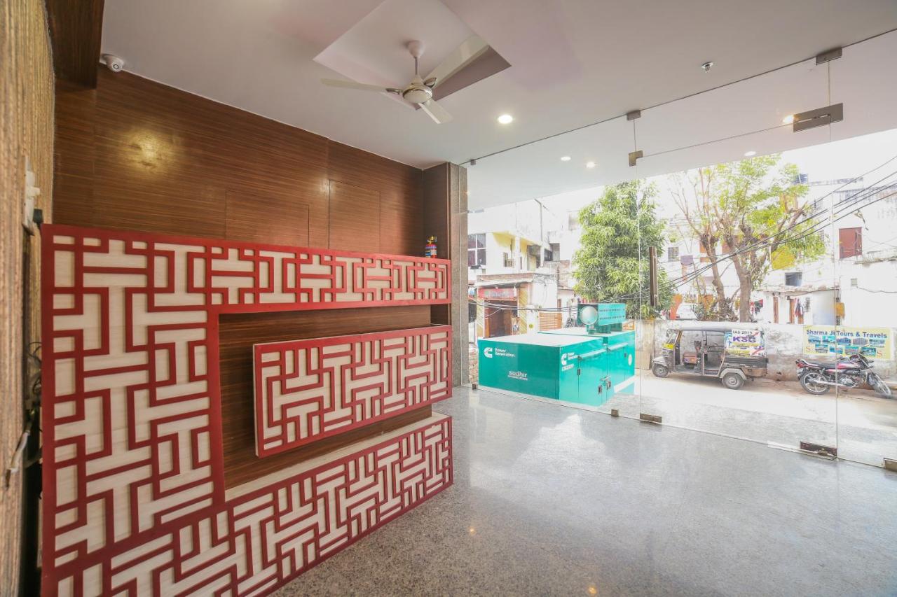 Red-and-white patterned reception desk stands at dog-friendly Hotel O Morgan in Bani Park.