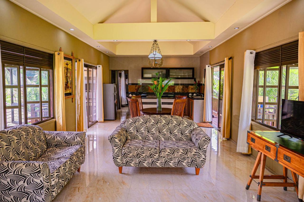 Black-and-white patterned loveseat sits at dog-friendly Villas des Alizes in Praslin Island.