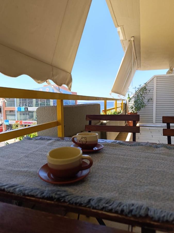 Two brown cups sit on a blue tablecloth at dog-friendly Nova Sea & City Apartments in Old Town Rethymnon.