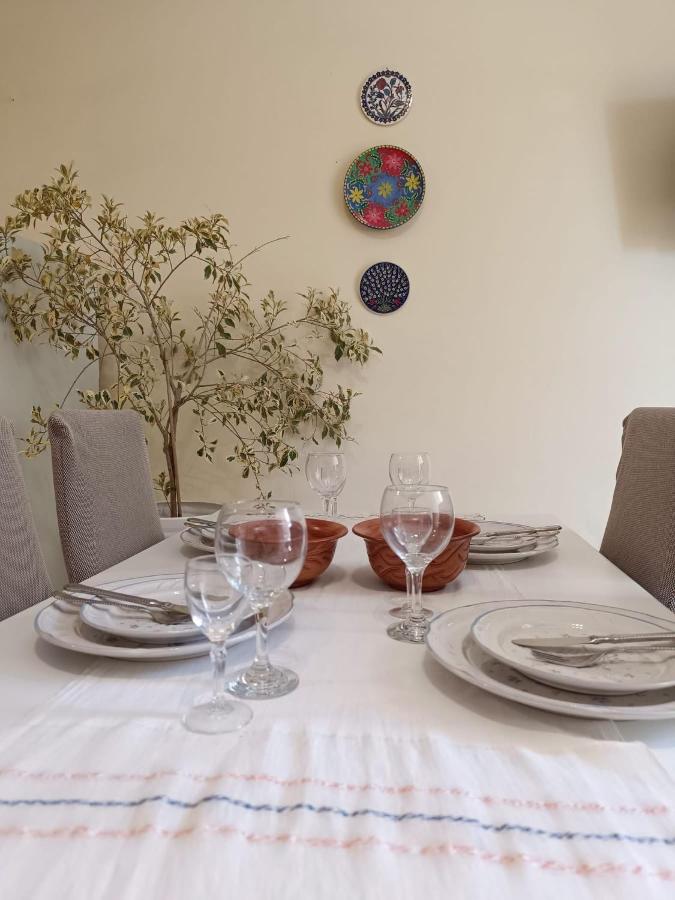 White table with clear wine glasses sits at pet-friendly Nova Sea & City Apartments in Old Town Rethymnon.