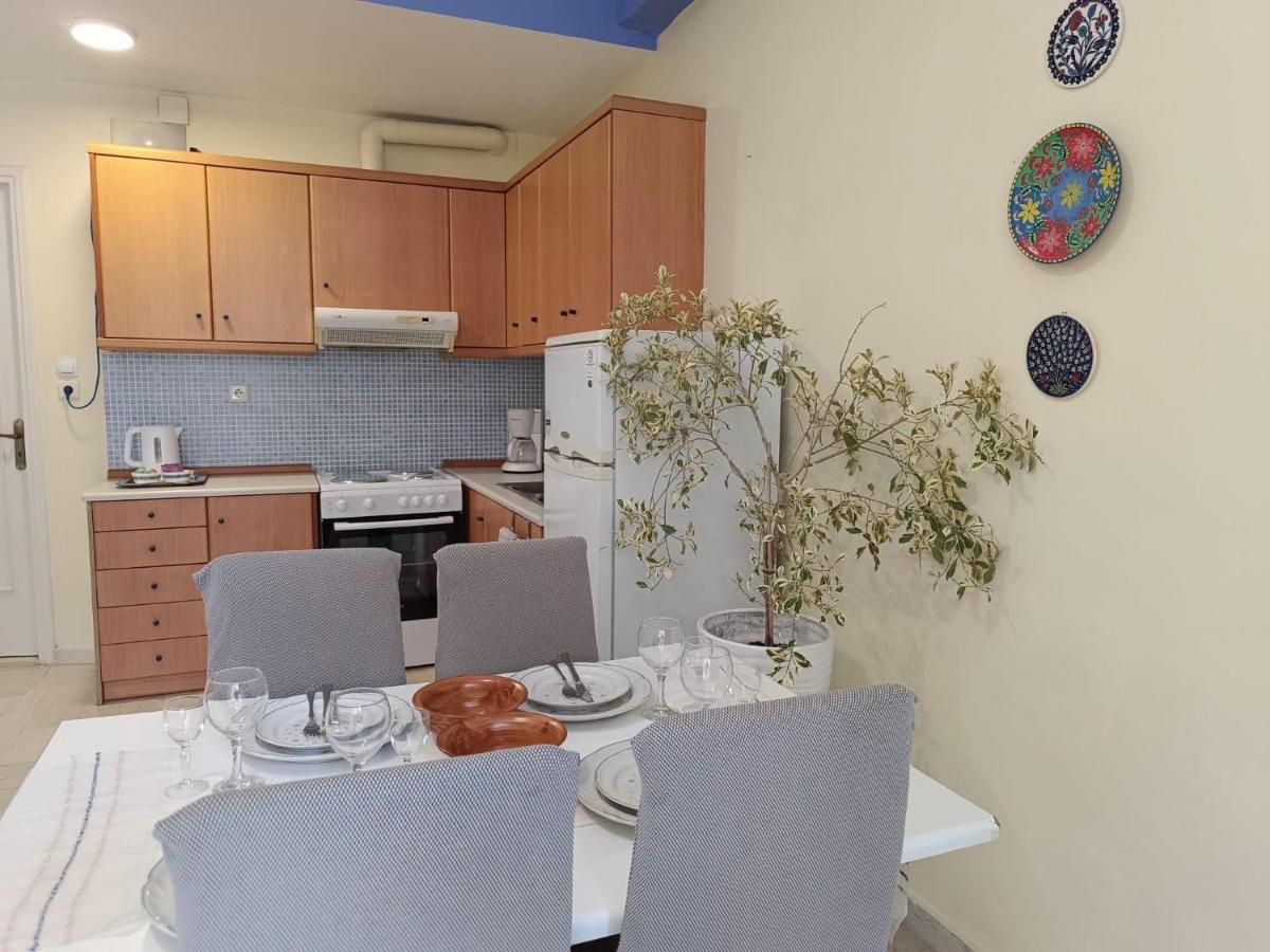Four gray fabric-covered dining chairs sit at pet-friendly Nova Sea & City Apartments in Old Town Rethymnon.