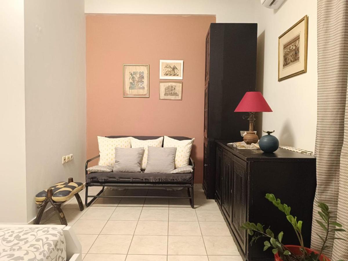 Black metal-frame sofa with striped pillows sits at dog-friendly Nova Sea & City Apartments in Old Town Rethymnon.