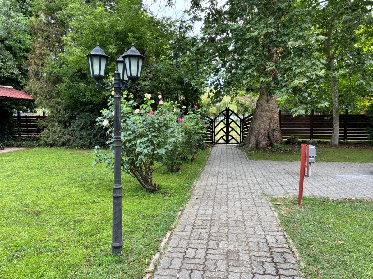 Black iron lamppost with three lanterns stands at pet-friendly Grantek Üdülház in Balatonlelle.