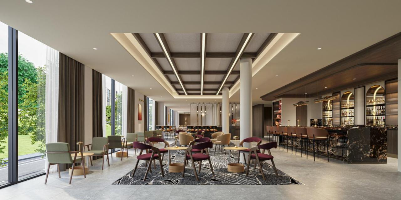 Burgundy-upholstered chairs are arranged at pet-friendly Crowne Plaza Melbourne Carlton by IHG in Melbourne.
