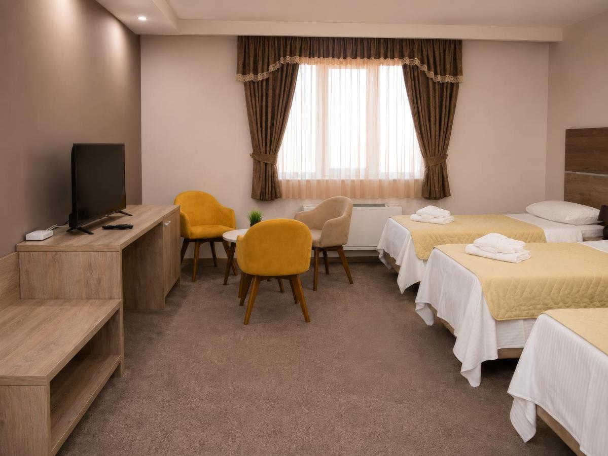 Three yellow upholstered chairs sit at pet-friendly Hotel Intergaj Bijeljina in Bijeljina.
