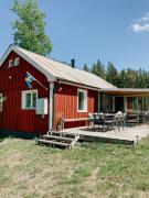 Luxurious red cottage with wood stove near lake