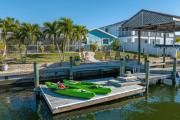 Pirates Den a 4BR Pet-Friendly Waterfront Oasis with Pool, Dock, Personal Water Boats, Fire Pit, Game Room and Bar
