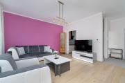 Dark Grey and Pink Apartment with Balcony and Free Parking in Poznań by Renters