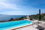 NEW! Three-bedroom Villa Sunshine with a heated pool, media room, and views of the sea