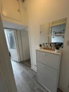 Bright bedroom with king side bed and share bathroom