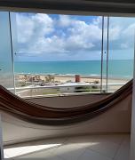 Flat pé na areia à beira-mar