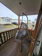 Rhyl Caravan with Veranda Egg Chairs & Garden