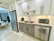 Modern 2 bedroom condo with heated pool, free parking spot at a 5 minute walk to the beach!