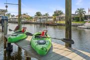 Pirates Den a 4BR Pet-Friendly Waterfront Oasis with Pool, Dock, Personal Water Boats, Fire Pit, Game Room and Bar