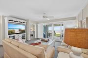 Ground floor direct oceanfront with a large patio, pool, and covered parking
