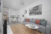 Bright Grey Apartment in Warsaw with Balcony by Noclegi Renters