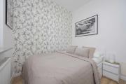 Bright Grey Apartment in Warsaw with Balcony by Noclegi Renters