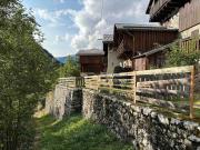 Mountain house with two barns and a garden