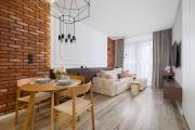 Rakowicka Brick Apartment near Station by Noclegi Renters