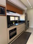 Apartamento moderno, a 200 metros da praia com pátio,piscina e churrasqueira privativa 2 vagas de garagem