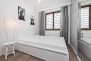 White and Grey Apartment in Cracow with Parking by Noclegi Renters