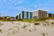 Modern oceanfront condo with outdoor pool, balcony, & washerdryer